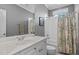 Bright bathroom with vanity, mirror and shower/tub combination featuring decorative curtain at 1209 Harp St, Raleigh, NC 27604