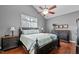 Bedroom with hardwood floors, a ceiling fan, a comfortable bed and dark wood furnishings at 1209 Harp St, Raleigh, NC 27604