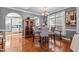 Cozy dining area featuring a wooden cabinet, modern lighting fixture, and views into the kitchen at 1209 Harp St, Raleigh, NC 27604