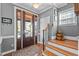 A foyer with a detailed front door, hardwood flooring, and bright white molding at 1209 Harp St, Raleigh, NC 27604