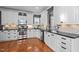 Bright kitchen with granite countertops, stainless steel appliances, and hardwood floors at 1209 Harp St, Raleigh, NC 27604