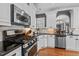 Well-equipped kitchen featuring granite counters, stainless appliances, and plenty of cabinet space at 1209 Harp St, Raleigh, NC 27604