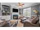 Cozy living room with a fireplace, built-in shelves, and comfortable seating area at 1209 Harp St, Raleigh, NC 27604