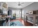 Bright office space featuring hardwood floors, a ceiling fan, and two large windows at 1209 Harp St, Raleigh, NC 27604