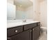 Bathroom vanity boasts dark wood cabinetry, white countertops, and a large mirror at 1218 S Franklin St, Wake Forest, NC 27587