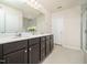 Modern bathroom with dual sinks, quartz countertops, and dark wood cabinetry at 1218 S Franklin St, Wake Forest, NC 27587