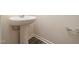 Bathroom featuring pedestal sink, modern fixtures, and wood-look flooring at 1218 S Franklin St, Wake Forest, NC 27587