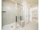 Tiled walk-in shower featuring a glass door and bench, bathed in natural light at 1218 S Franklin St, Wake Forest, NC 27587