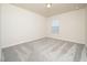 Bedroom with neutral walls, carpet, and natural light from a window offers a cozy feel at 1218 S Franklin St, Wake Forest, NC 27587