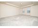 A bright bedroom with a trey ceiling features plush carpeting and natural light from large windows at 1218 S Franklin St, Wake Forest, NC 27587