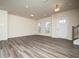 Inviting open living area showcasing wood-look floors, two windows and a front door entrance at 1218 S Franklin St, Wake Forest, NC 27587