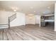 Spacious living area with staircase and kitchen featuring wood-look flooring at 1218 S Franklin St, Wake Forest, NC 27587