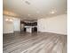Open-concept living room featuring wood-look flooring and seamlessly flowing into a modern kitchen area at 1218 S Franklin St, Wake Forest, NC 27587