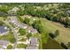 Picturesque aerial view of luxurious homes overlooking a meticulously manicured golf course at 12527 Bellstone Ln, Raleigh, NC 27614
