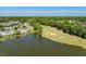 Expansive aerial view of a charming lakeside community with lush landscaping and a pristine golf course at 12527 Bellstone Ln, Raleigh, NC 27614