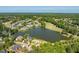 Sprawling aerial perspective showcasing a lakeside community featuring waterfront homes and a pristine golf course at 12527 Bellstone Ln, Raleigh, NC 27614