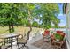 Enjoy serene views of the lush golf course and lake from the inviting back deck with comfortable seating at 12527 Bellstone Ln, Raleigh, NC 27614