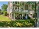 Charming backyard patio with covered seating area and an elevated deck overlooking the landscaped lawn at 12527 Bellstone Ln, Raleigh, NC 27614
