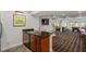 Open basement area with kitchenette, staircase, and living space featuring a pool table at 12527 Bellstone Ln, Raleigh, NC 27614