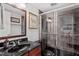 Modern bathroom with dark tile, a glass-enclosed shower, and a vanity with marble countertop at 12527 Bellstone Ln, Raleigh, NC 27614