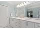 Bathroom featuring double sinks, a large mirror, and ample counter space at 12527 Bellstone Ln, Raleigh, NC 27614