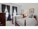 Charming bedroom with two twin beds, polka dot curtains, and traditional decor at 12527 Bellstone Ln, Raleigh, NC 27614