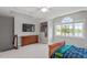 Spacious bedroom with window, dresser, tv, and bed at 12527 Bellstone Ln, Raleigh, NC 27614