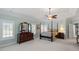 Spacious main bedroom featuring a tray ceiling, sitting area, and large windows at 12527 Bellstone Ln, Raleigh, NC 27614
