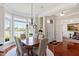 Bright dining room with hardwood floors, chandelier, and a picturesque lake view at 12527 Bellstone Ln, Raleigh, NC 27614