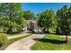 Large, well-maintained brick home with an expansive driveway and mature trees at 12527 Bellstone Ln, Raleigh, NC 27614