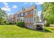 Charming brick home features a side deck, manicured lawn, and mature trees at 12527 Bellstone Ln, Raleigh, NC 27614