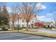 Elegant multi-story building featuring a manicured lawn and ample parking at 12527 Bellstone Ln, Raleigh, NC 27614