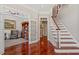 Inviting foyer with hardwood floors, staircase, and study featuring French doors and built-in bookcase at 12527 Bellstone Ln, Raleigh, NC 27614