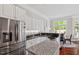 Bright kitchen features stainless steel appliances, granite countertops and a center island, adjacent to breakfast nook at 12527 Bellstone Ln, Raleigh, NC 27614
