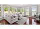 Inviting living room with plush seating, hardwood floors, and beautiful lake views at 12527 Bellstone Ln, Raleigh, NC 27614