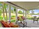 Relaxing covered patio with comfortable seating, overlooking a lake and the golf course at 12527 Bellstone Ln, Raleigh, NC 27614