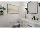 Elegant powder room with white vanity, modern fixtures, and stylish decor at 12527 Bellstone Ln, Raleigh, NC 27614