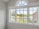 Window view showcases the property's beautiful pond and lawn at 12527 Bellstone Ln, Raleigh, NC 27614