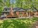 A spacious backyard with a deck and lots of green grass at 12537 Birchfalls Dr, Raleigh, NC 27614