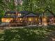 Spacious backyard with large deck, lush green lawn, and mature trees at 12537 Birchfalls Dr, Raleigh, NC 27614