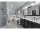 Stylish bathroom featuring double sinks, soaking tub, and a glass shower at 12537 Birchfalls Dr, Raleigh, NC 27614