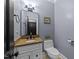 Bathroom features a single vanity, commode, and natural lighting at 12537 Birchfalls Dr, Raleigh, NC 27614