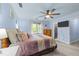 Cozy bedroom with natural light, a ceiling fan, and soft, inviting bedding at 12537 Birchfalls Dr, Raleigh, NC 27614