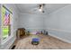Bright bonus room featuring a ceiling fan, wood floors, and a sunny window at 12537 Birchfalls Dr, Raleigh, NC 27614