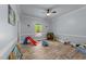 Bright bonus room featuring a ceiling fan, wood floors, and multiple toys at 12537 Birchfalls Dr, Raleigh, NC 27614