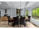 Bright dining room featuring large windows overlooking lush greenery and vaulted ceilings at 12537 Birchfalls Dr, Raleigh, NC 27614