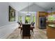 Dining room featuring a long wood table and natural light from large windows overlooking the backyard at 12537 Birchfalls Dr, Raleigh, NC 27614