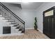An open foyer with wood-look floors, a staircase, and modern decorations at 12537 Birchfalls Dr, Raleigh, NC 27614