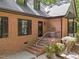 The property has a welcoming brick staircase, beautiful plants, and elegant black accents at 12537 Birchfalls Dr, Raleigh, NC 27614