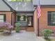 Charming brick home with a front entry and American flag at 12537 Birchfalls Dr, Raleigh, NC 27614